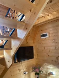 a room with wooden walls and a flat screen tv at Bungalow Jajce 2 in Jezero
