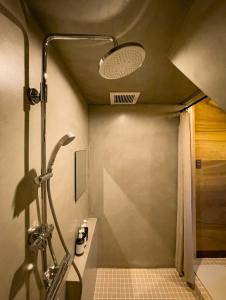 a bathroom with a shower with a sink and a shower at 暮らすように過ごすNagi unoport in Uno