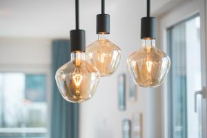 a group of glass lights hanging from a ceiling at FiNEST Design Stuttgart Airport Messe in Ostfildern
