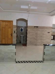 Habitación con baño con aseo y puerta. en Appartements de luxe à Al Mahdi, en Dakhla