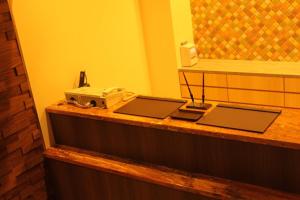 a counter with two laptops and a telephone on it at Hotel Richie Richie - Vacation STAY 25058v in Osaka