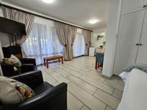 a living room with a couch and a table at Ndiza Lodge and Cabanas in St Lucia