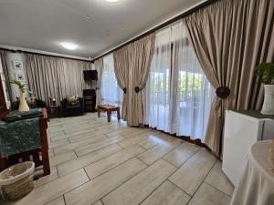a living room with wooden floors and large windows at Ndiza Lodge and Cabanas in St Lucia +97 photos