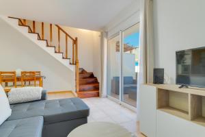 a living room with a couch and a tv at Villa Holiday Sun by Holiday Rental Madeira in Ponta do Sol