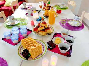 a table with breakfast foods and drinks on it at chambres d'hôtes Au Gré du Vent en Normandie in Malleville-les-Grès