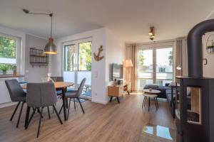 ein Wohnzimmer und ein Esszimmer mit einem Tisch und Stühlen in der Unterkunft Ferienwohnung "Haffsonne" - Whg 7 10 in Zirchow