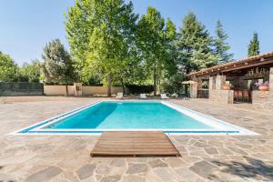 una piscina in un cortile con terrazza in legno di Villa OINOI with Pool for Luxury Vacation and Events a Marathónas (Maratona)