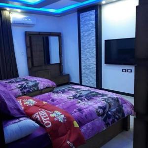 Кровать или кровати в номере Appartements de luxe à Al Mahdi