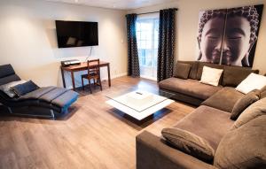 a living room with a couch and a table at L'Évasion in Lambton