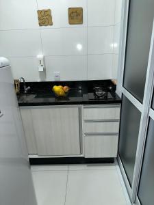 a kitchen with a sink and a bowl of fruit on the counter at RESIDENCIAL WRUBLESKI ANEXO in Palhoça