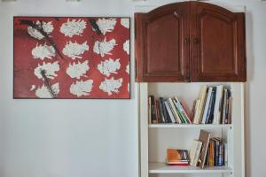 a cabinet and a book shelf with books at Antiche Mura - Bassano Dieda in Bassano del Grappa