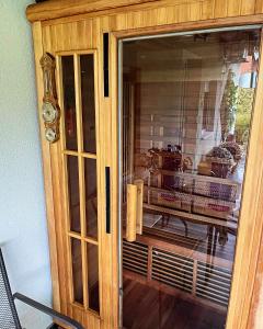 a wooden cabinet with a glass door with food inside at Mirka in Sremski Karlovci