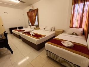 Un pat sau paturi într-o cameră la Taman Bahagia Homestay