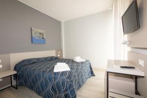 Postel nebo postele na pokoji v ubytování Hotel Nember
