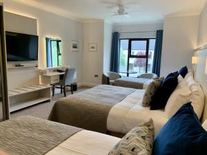 Voodi või voodid majutusasutuse Mill Park Hotel toas