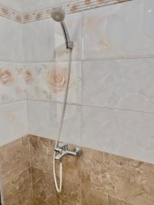 a shower with a shower head in a bathroom at Hà Tiên Hạnh Phúc Hotel in Hà Tiên