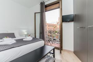 a bedroom with a bed and a balcony at Lodging Sant Pau Views- Suite with View on Hospital Sant Pau in Barcelona
