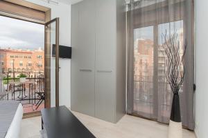 a living room with a large window and a vase at Lodging Sant Pau Views- Suite with View on Hospital Sant Pau in Barcelona