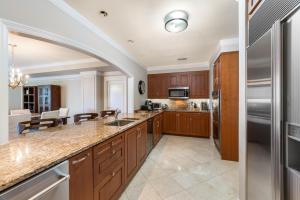 a kitchen with wooden cabinets and stainless steel appliances at Ocean View Residence 608 located at The Ritz-Carlton in Upper Land
