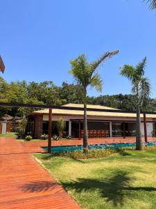 a building with palm trees in front of it at Tiradentes Boutique Hotel in Tiradentes