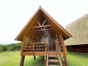 a small house with a staircase leading up to it at Chalé Caiçara in Caraguatatuba