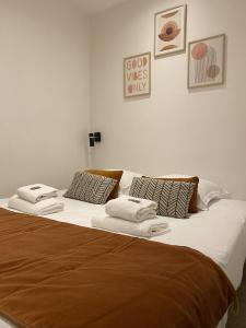 uma cama grande com lençóis brancos e toalhas em St Germain-Bon Marché - cosy n°2 em Paris