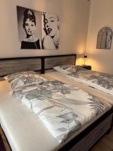 two beds in a bedroom with posters on the wall at Victoria Apartment in Chemnitz