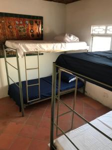 a room with two bunk beds and a table at RiverMan Hostel, Tourism and Friends in Jagua