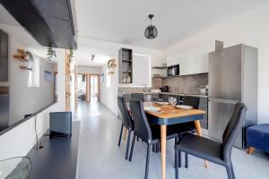 cocina y comedor con mesa y sillas en Stunning 2BR Holiday Penthouse in Central Sliema en Sliema