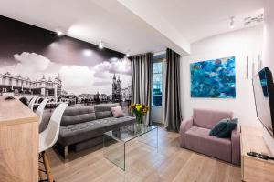 a living room with a couch and a table at Premium Apartments by Wawel Castle in Krakow