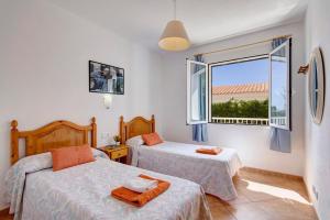 a bedroom with two beds and a window at Villa Santo Grande by Villa Plus in Santo Tomás