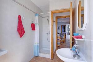 a bathroom with a sink and a shower at Villa Santo Grande by Villa Plus in Santo Tomás +19 photos