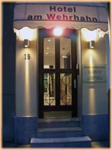 a hotel entrance with a door and a sign on it at Hotel Am Wehrhahn in Düsseldorf