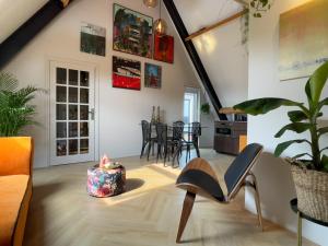 ein Wohnzimmer mit einem Stuhl und einem Tisch in der Unterkunft Sfeervol appartement 'Le Boulanger' in Franeker. in Franeker