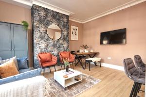 a living room with a couch and a table at Homebird Property - Haddon House in Leeds