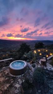 a hot tub sitting on top of a hill with a sunset at STUDIO CASA FERMEGLIA for two people in Roč
