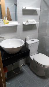 a bathroom with a white toilet and a sink at Deluxe Room have Balcony D1-Dakao in Ho Chi Minh City