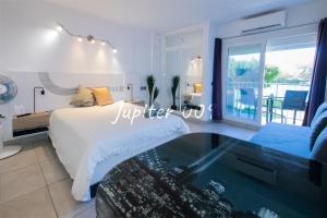 a bedroom with a bed and a glass table at J009 - Studio - Complex Minerva & Jupiter in Benalmádena