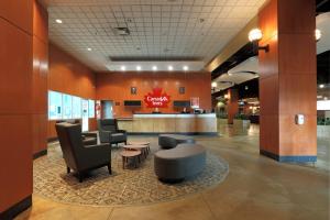 a lobby of a hotel with chairs and a counter at Canad Inns Destination Centre Brandon in Brandon