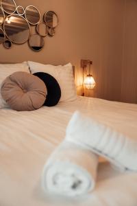 a white bed with two pillows and a blanket at Hotel bij Jacob in Enschede