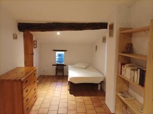 a bedroom with a bed and a book shelf at La petite Corbières in Roquefort-des-Corbières