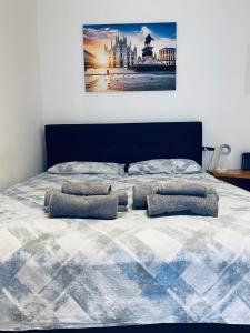 Una cama con cuatro almohadas encima. en Casa Cavaleri Sweet apartment MM Bande Nere, en Milán