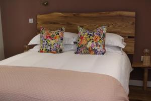 a bed with white sheets and pillows at The Kings Head Inn, Norwich - AA 5-Star rated in Norwich