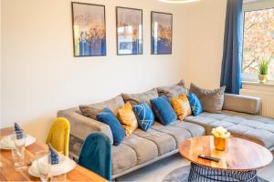 a living room with a couch and two tables at Comfort Suite - Family+Business in Gießen