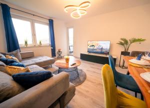a living room with a couch and a tv at Comfort Suite - Family+Business in Gießen