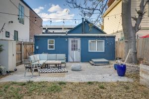 a blue shed with a table and chairs in a yard at Cozy and Pet-Friendly Home - 3 Mi to Downtown Denver in Denver