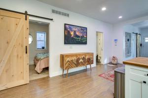 a room with a wooden door and a bedroom at Cozy and Pet-Friendly Home - 3 Mi to Downtown Denver in Denver