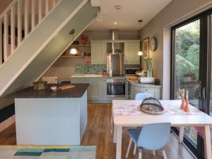 a kitchen with a table and a staircase at The Granary Owl House in Gainsborough