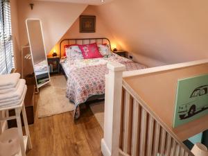 a bedroom with a bed and a staircase at The Granary Owl House in Gainsborough