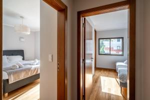 a bedroom with a bed and a large mirror at Oeiras apt in Spacious Villa - Shared Pool in Oeiras